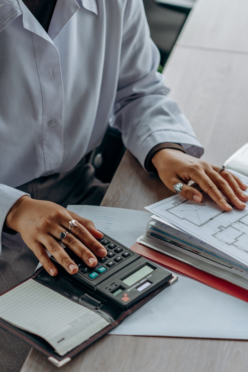 Canadian tax preparer organizing documents with calculator and digital screen